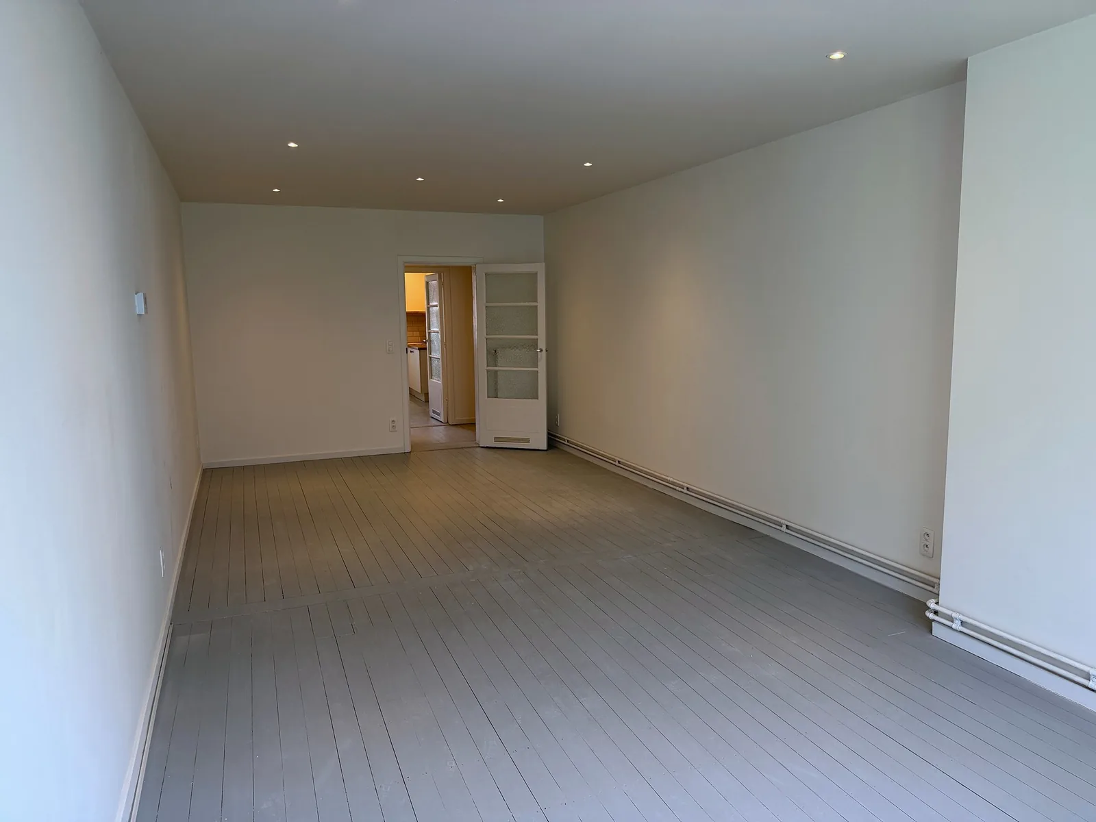 Leefruimte met zicht naar de aparte keuken studio Antwerpen Zuid